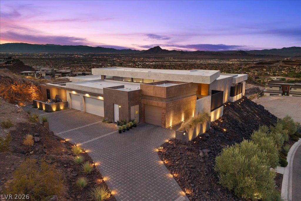 Image 1: Perched on a hillside, this contemporary desert ho