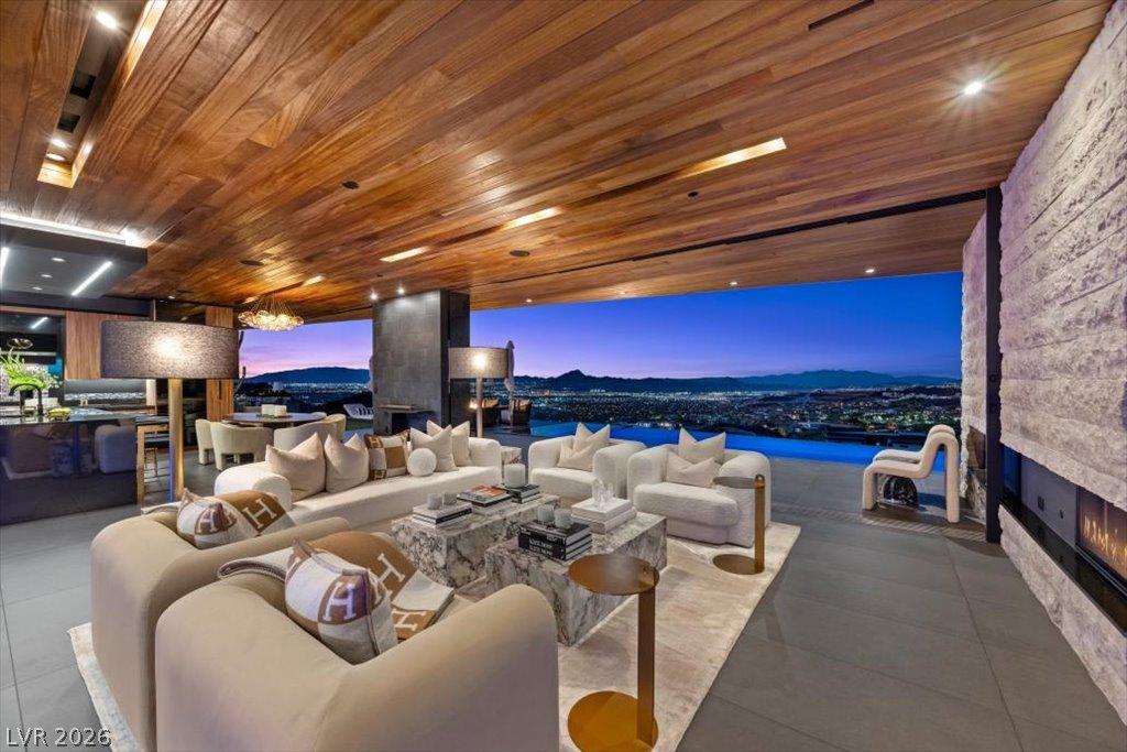 Image 3: An open-concept living space with a wooden ceiling