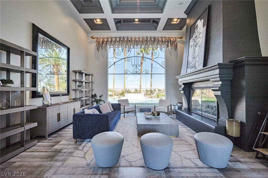 Image 1: Grand living room with a coffered ceiling, a large
