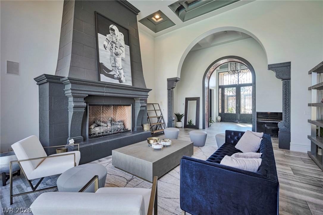 Image 2: An opulent fireplace anchors this spacious living