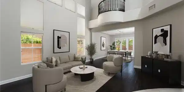 Image 2: A spacious living room features soaring ceilings,