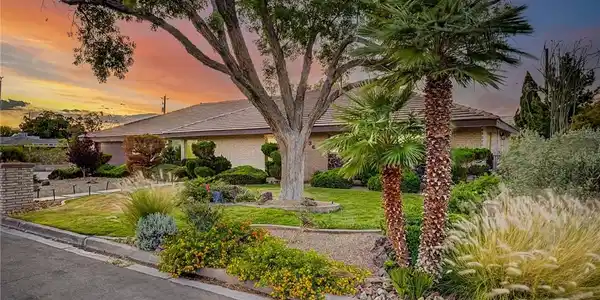 Image 3: Manicured landscaping and mature trees frame this
