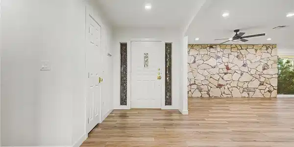 Image 4: Enter into a bright, open living space featuring r