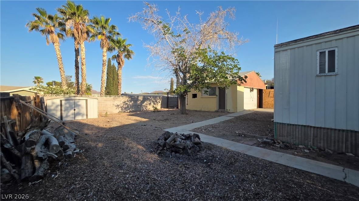 Image 3: A spacious backyard with a convenient storage shed