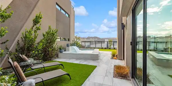 Image 3: An inviting courtyard features modern stone tile p
