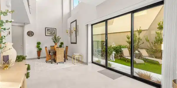 Image 4: MAIN LEVEL FOYER-Massive sliding glass doors open