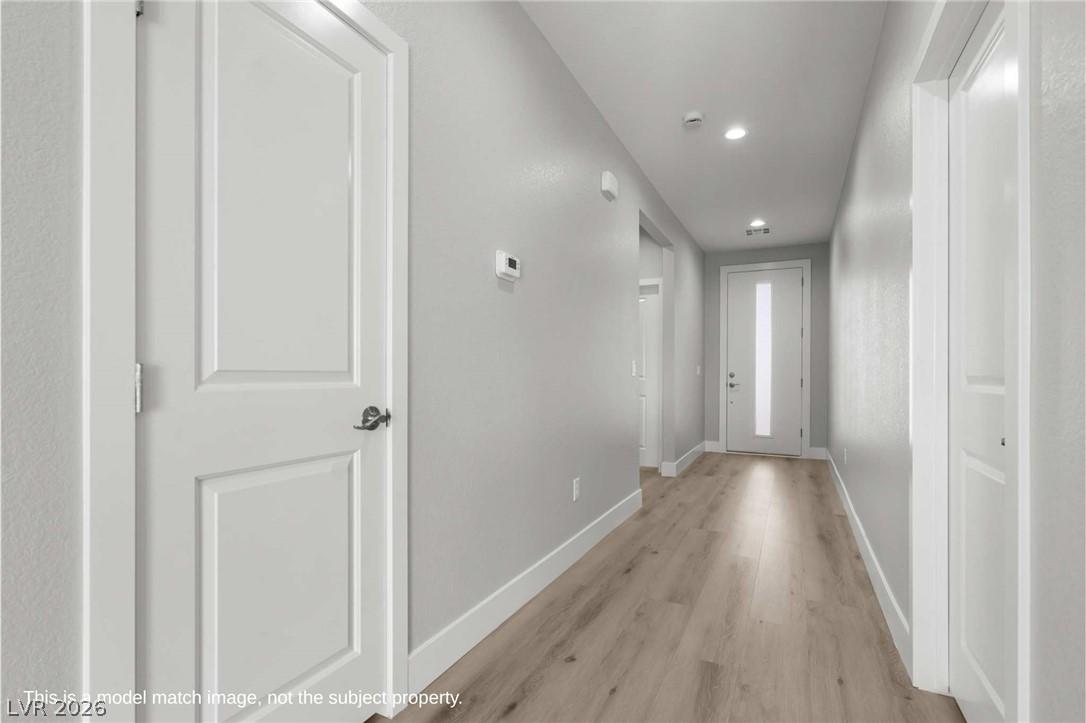 Image 3: Hallway featuring light wood finished floors and r