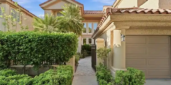 Image 4: A gated entrance with courtyard featuring manicure