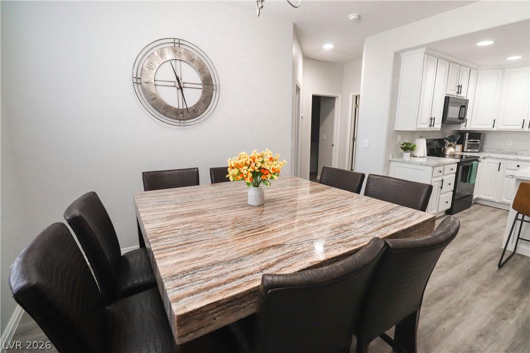 Image 3: Seamless flow between the dining and kitchen. This