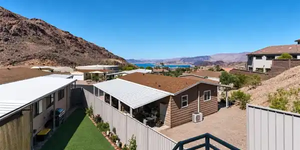 Image 2: Perched above the lake, this property presents a s
