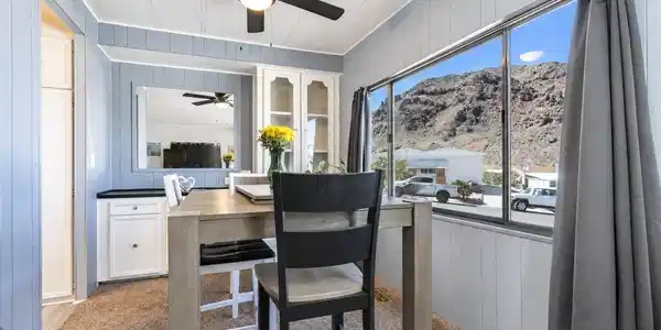 Image 4: A casual dining space features a window framing a