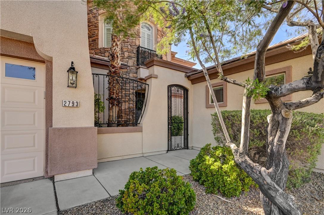 Image 3: A well-maintained stucco facade with stone accents