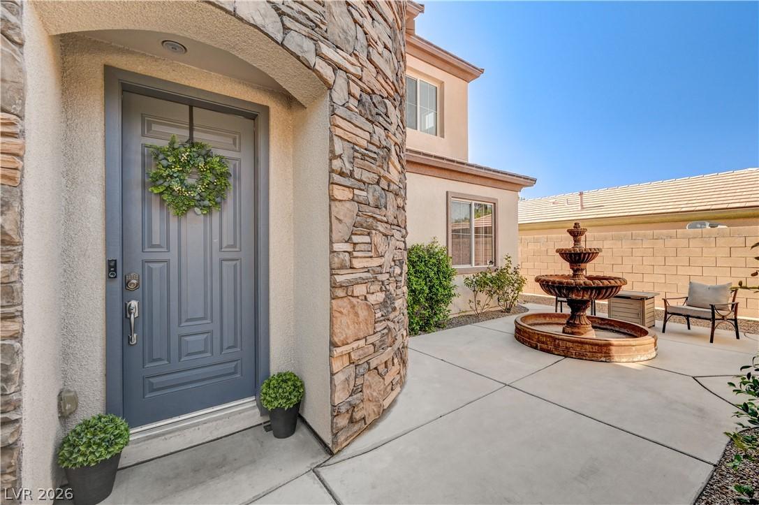 Image 4: An inviting stone and stucco facade greets you wit