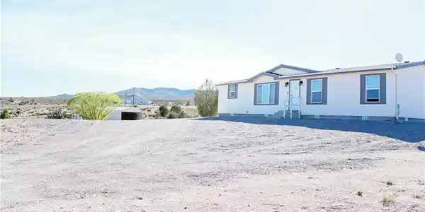 Image 3: Perched on a wide-open lot, this single-level resi
