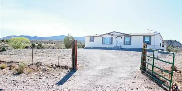 Image 4: A fenced, expansive lot with distant mountain view