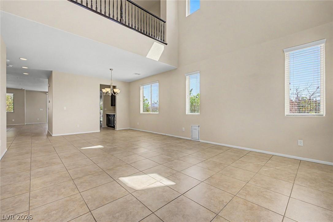 Image 3: A spacious living area features high ceilings and