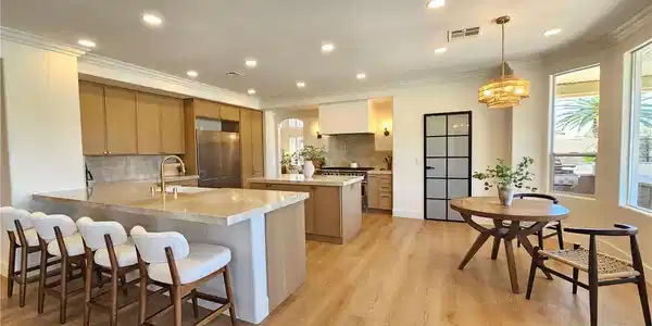 Image 3: Polished stone countertops and seamless wood floor