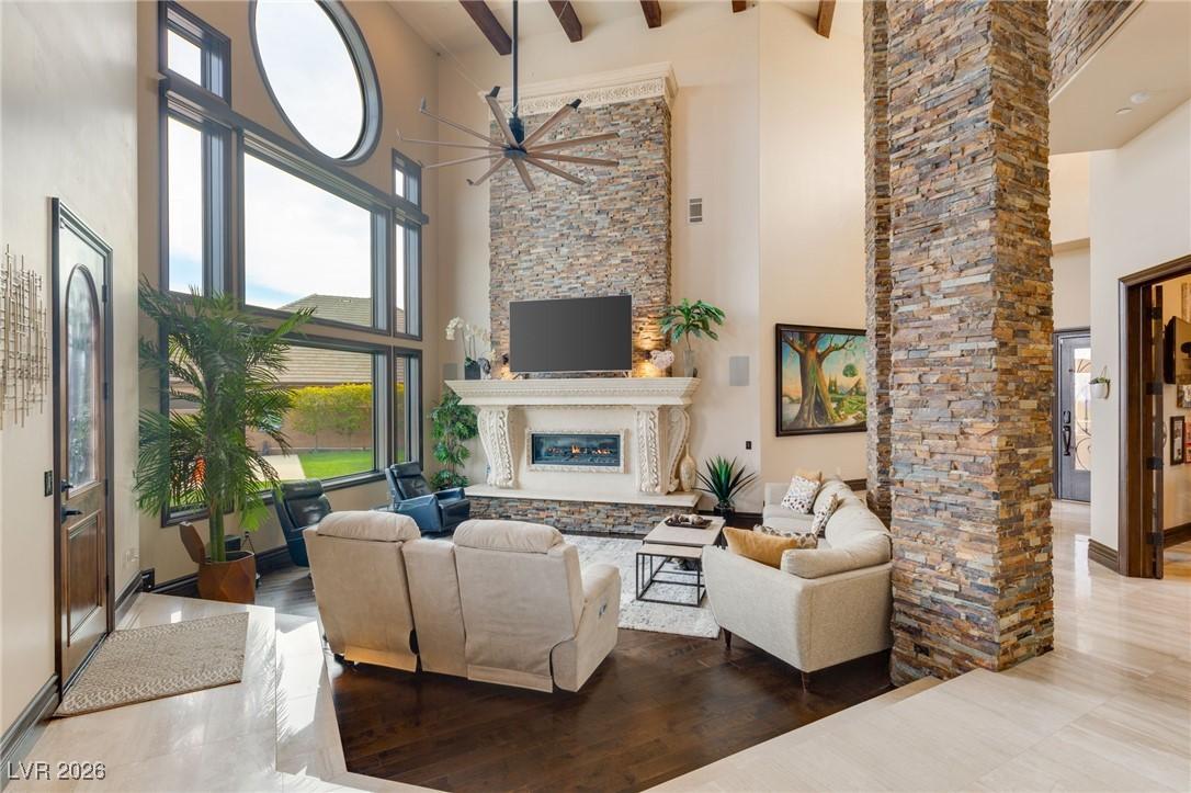 Image 3: Living room with a towering ceiling, ceiling fan,