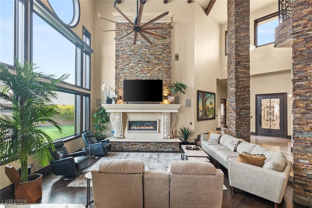 Image 4: Living area featuring a glass covered fireplace, a