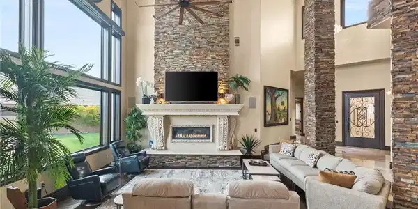 Image 4: Living area featuring a glass covered fireplace, a