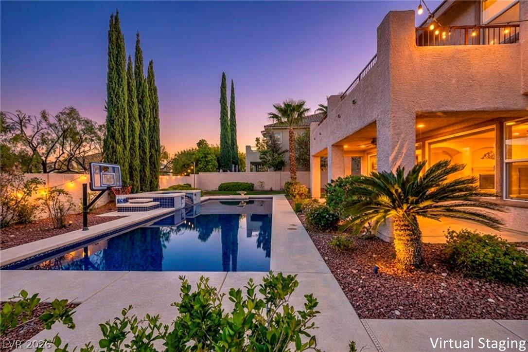 Image 1: An inviting backyard oasis features a shimmering p