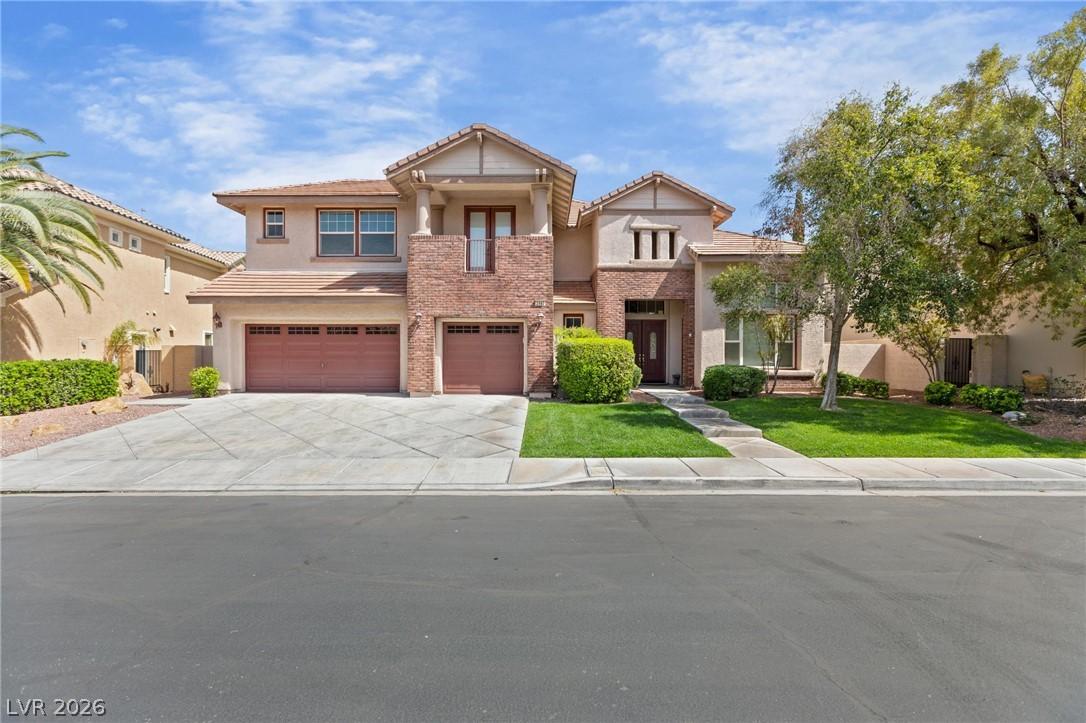 Image 2: A striking stucco and brick residence features a w