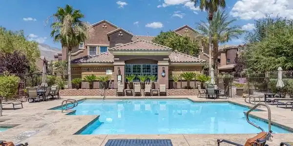 Image 3: An inviting pool area with ample lounge seating an