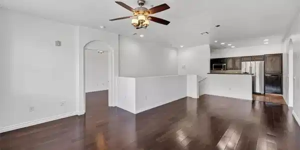 Image 4: Rich hardwood floors flow through this open-concep