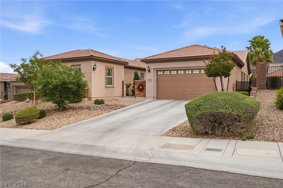 Image 3: A well-maintained stucco residence boasts an attac