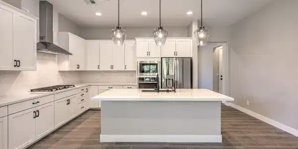 Image 3: Gleaming stone countertops and a spacious central