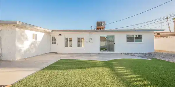 Image 4: An inviting concrete patio overlooks the manicured