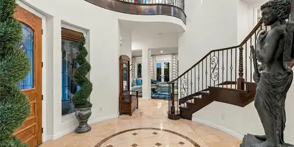 Image 3: Polished tile flooring and a sweeping staircase we