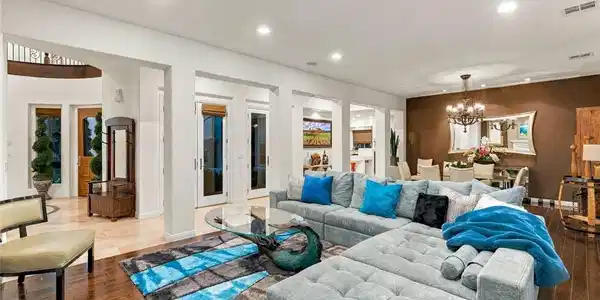 Image 4: Rich hardwood floors complement an airy layout tra