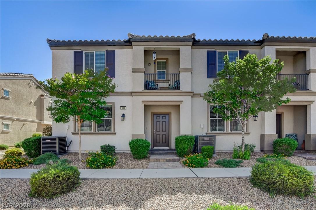 Image 2: This townhome features an inviting facade with lus