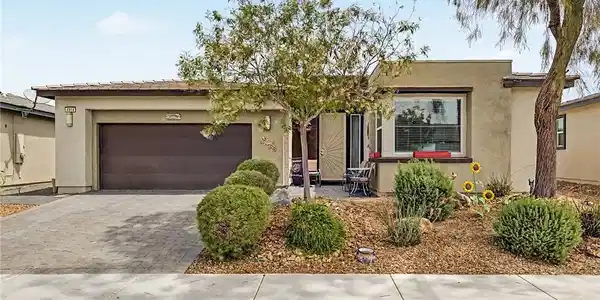 Image 4: An inviting entry and manicured landscaping grace