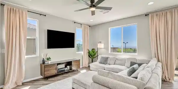 Image 3: Recessed lighting and a ceiling fan illuminate thi