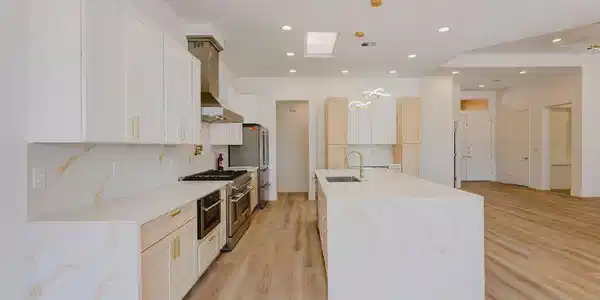Image 3: An open kitchen showcases sleek stone countertops