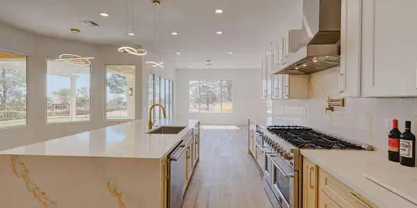 Image 4: An open kitchen design showcases sleek countertops