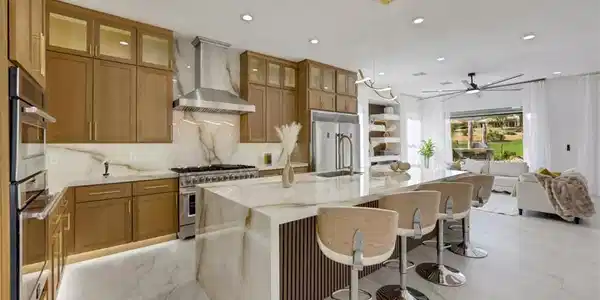 Image 4: Warm wood cabinetry and elegant stone counters anc