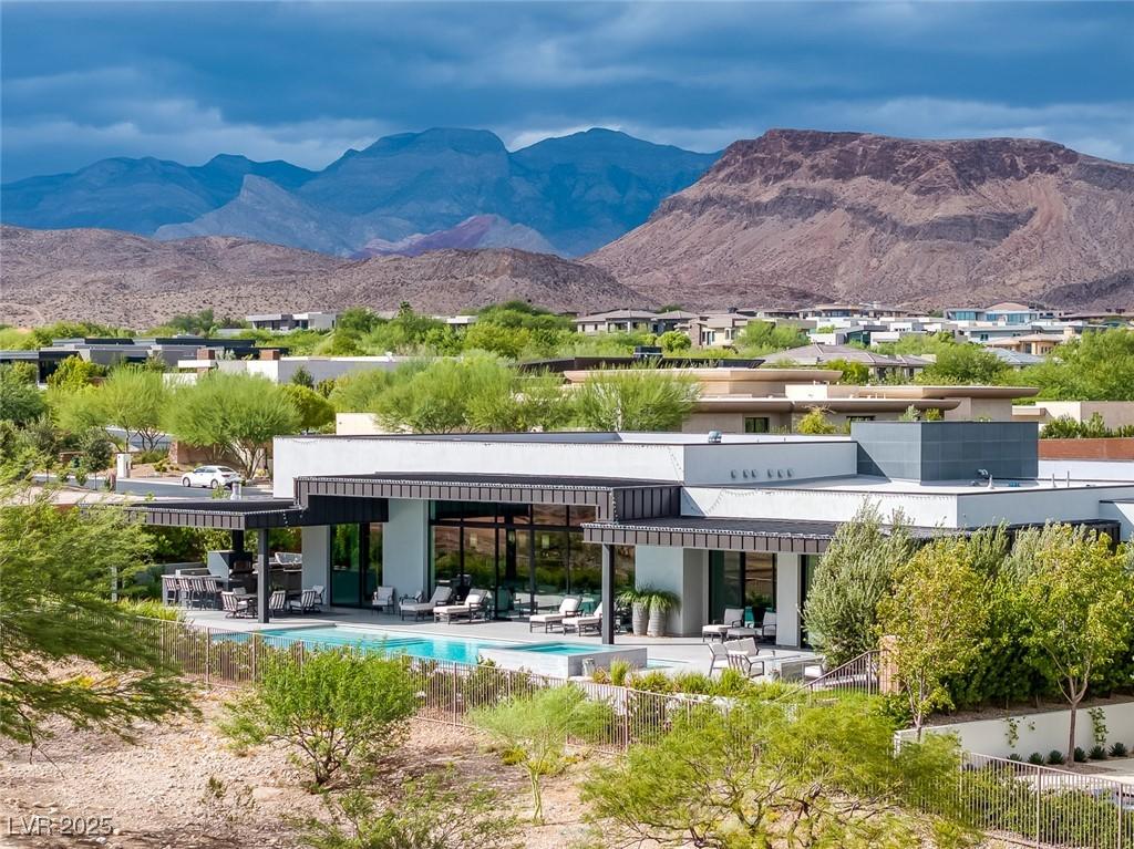 Image 1: Rear view of property with a patio, a mountain vie