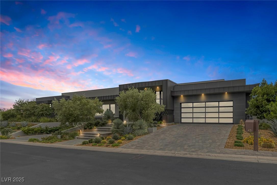 Image 2: Modern home featuring decorative driveway and an a