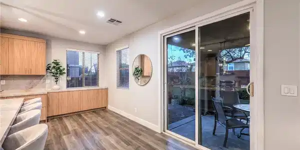 Image 3: Sliding glass doors connect the bright dining area