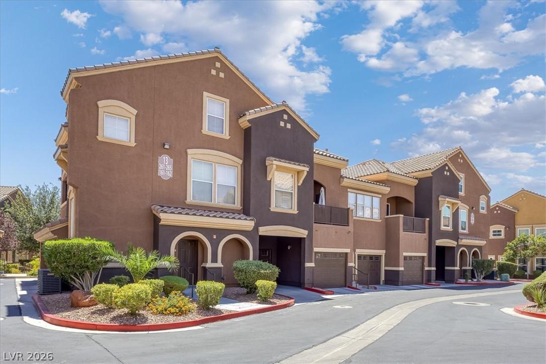 Image 1: These multi-story townhomes feature arched entrywa