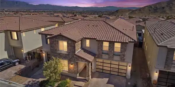 Image 4: Dusk skies frame this multi-level home featuring s