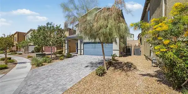 Image 3: A contemporary stucco residence with an integrated