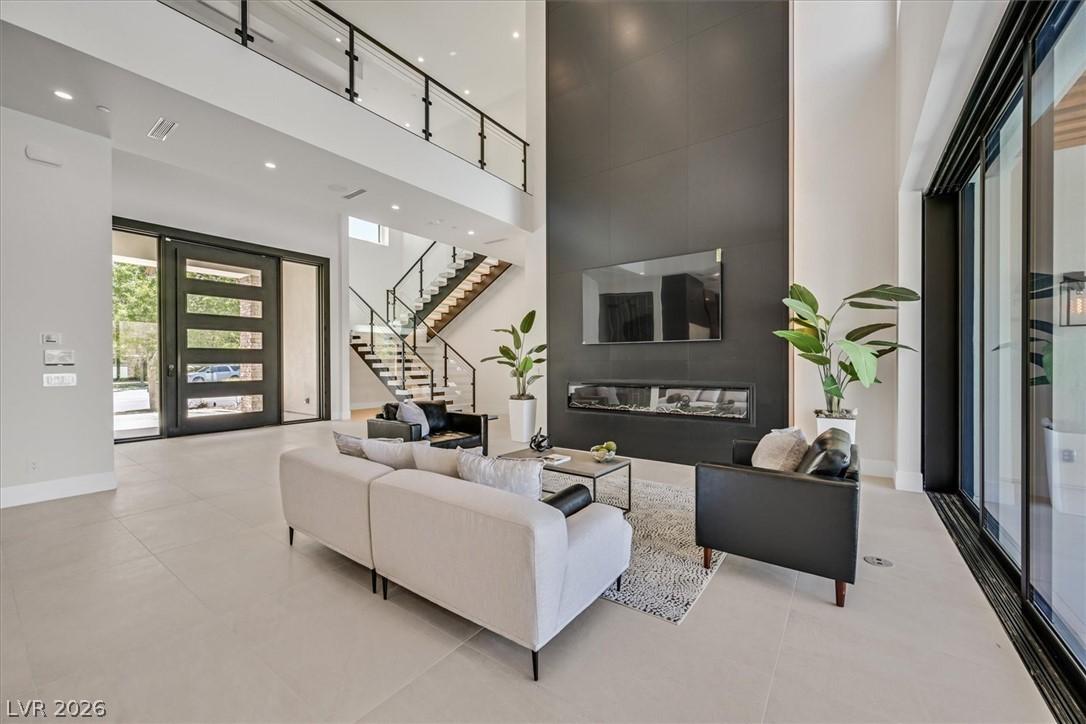 Image 3: A grand entrance with high ceilings, an elegant st