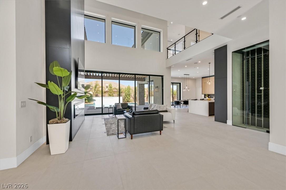 Image 4: A grand, open-concept living space with soaring ce