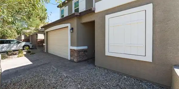 Image 3: Attractive stucco exterior features classic stone