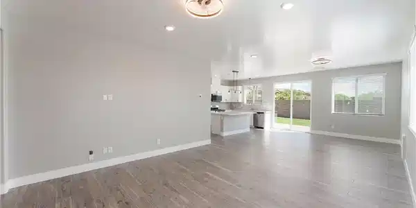Image 4: Gleaming wood-look tile floors stretch across a se