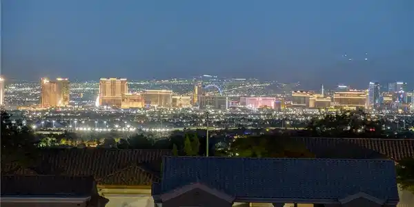 Image 3: City lights glimmer across the horizon, offering a